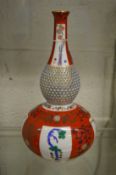 A Herend porcelain double gourd bottle vase in the Japanese taste with reticulated neck.