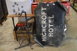 A large wrought iron sign bracket and sign.