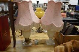 A pair of alabaster table lamps.