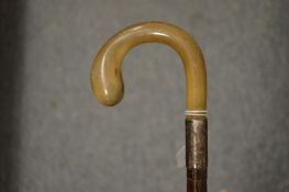 A horn and silver mounted parasol handle.