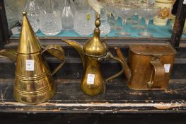 Two brass ewers and a copper barge kettle or watering can.