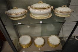 A gilt decorated part dinner service comprising three tureens, numerous plates.