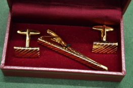 A cufflink and tie set.
