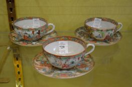 Three Chinese Canton cups and saucers.