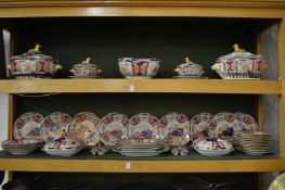 A comprehensive 19th century Imari decorated ironstone dinner service comprising tureens,