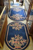 Three matching blue ground, floral decorated Chinese rugs.