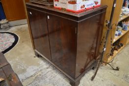 A mahogany two door cabinet.
