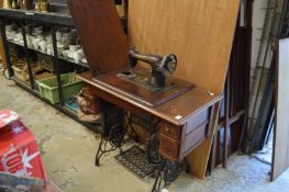 A Singer treadle operated sewing machine.