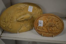 A small biscuit porcelain oval plaque and a pie dish cover.