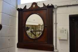 A decorative mahogany overmantle mirror with porcelain plaque.