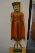 A carved and painted wood Thai standing figure.