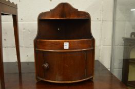A mahogany hanging corner cupboard.