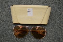 A cased pair of sunglasses.