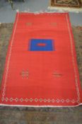 A large red ground Kilim rug.