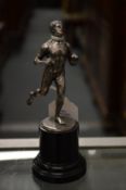 A small plated model of a runner.