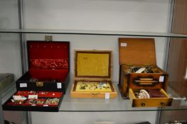 Three jewellery boxes containing a quantity of earrings and other costume jewellery.