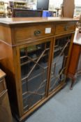 A mahogany bookcase with two drawers over two astragal glazed doors.