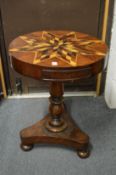 A 19th century mahogany drum table, the top inlaid with specimen woods to a star design.