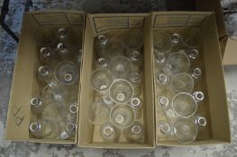 Three boxes of clear glass light shades.