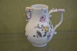 A small Meissen jug painted with flowers.