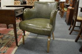 A green leather upholstered library armchair on tapering turned legs.