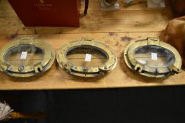 Three old oval shaped portholes.