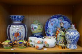 A shelf of oriental ceramics.