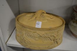 A bisque porcelain game pie dish and cover.