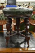 A 19th century green leather button upholstered revolving music seat.