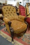 A Victorian carved mahogany framed, button upholstered armchair.