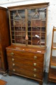 A George III mahogany secretaire chest with bookcase top.