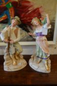 A pair of continental bisque porcelain figures.