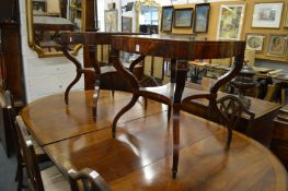 A good pair of mahogany and inlaid two tier occasional tables of shaped square outline on curving