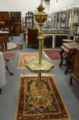 A brass and onyx adjustable floor standing oil lamp.