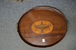 A good Edwardian oval mahogany tray inlaid with a classical urn.
