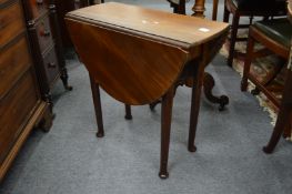A small mahogany drop-leaf table.