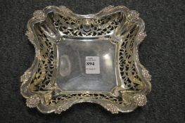 A square shaped silver dish with pierced sides.