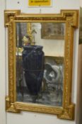 A decorative gilt framed mirror.