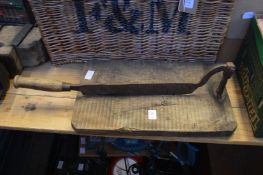 A wooden chopping board with hinged chopper.