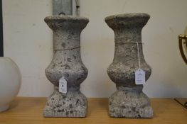 A pair of small composite stone balustrade style stands.