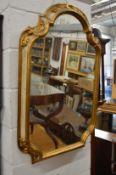 A decorative gilt framed mirror.