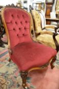 A Victorian rosewood framed button upholstered nursing chair.