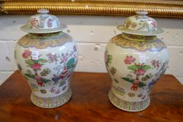 A pair of Chinese Famille Rose temple jars and covers.