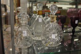 Five glass decanters.
