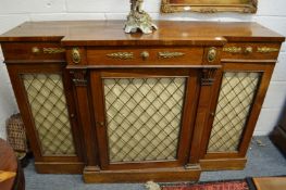 A good Regency rosewood break-front chiffonier with frieze drawers above brass grilled doors.