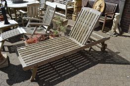 A hardwood reclining garden lounger.