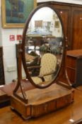 A large 19th century mahogany oval dressing table mirror with two drawers to the base.