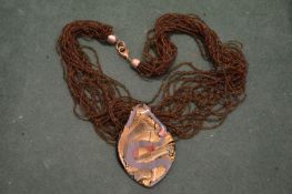 A decorative pendant and chain.