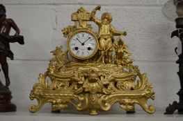 A decorative French gilt metal mantle clock.