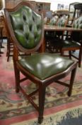 A set of eight mahogany and leather upholstered shield back dining chairs with button upholstered